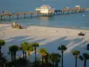 Clearwater Beach's white sand and palms, with a long pier on the water