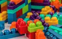 Colorful plastic toy building blocks stacked in rows