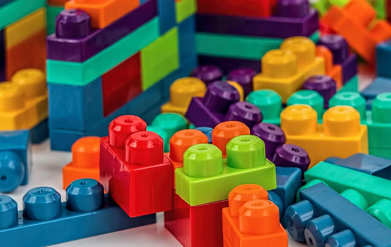 Colorful plastic toy building blocks stacked in rows