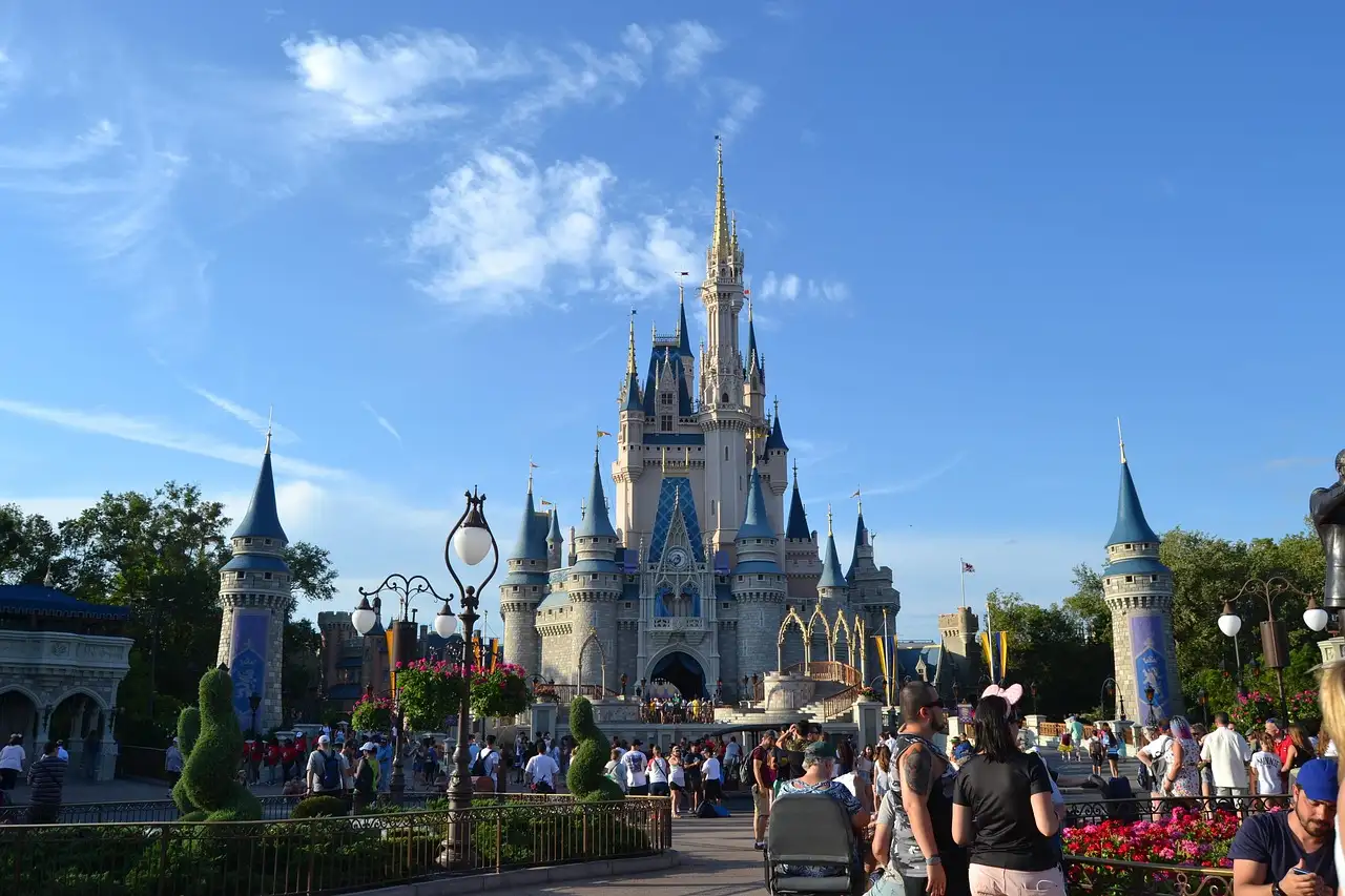 Cinderella Castle at Walt Disney World's Magic Kingdom on a sunny day with visitors on the street