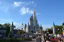 Cinderella Castle at Walt Disney World's Magic Kingdom on a sunny day with visitors on the street