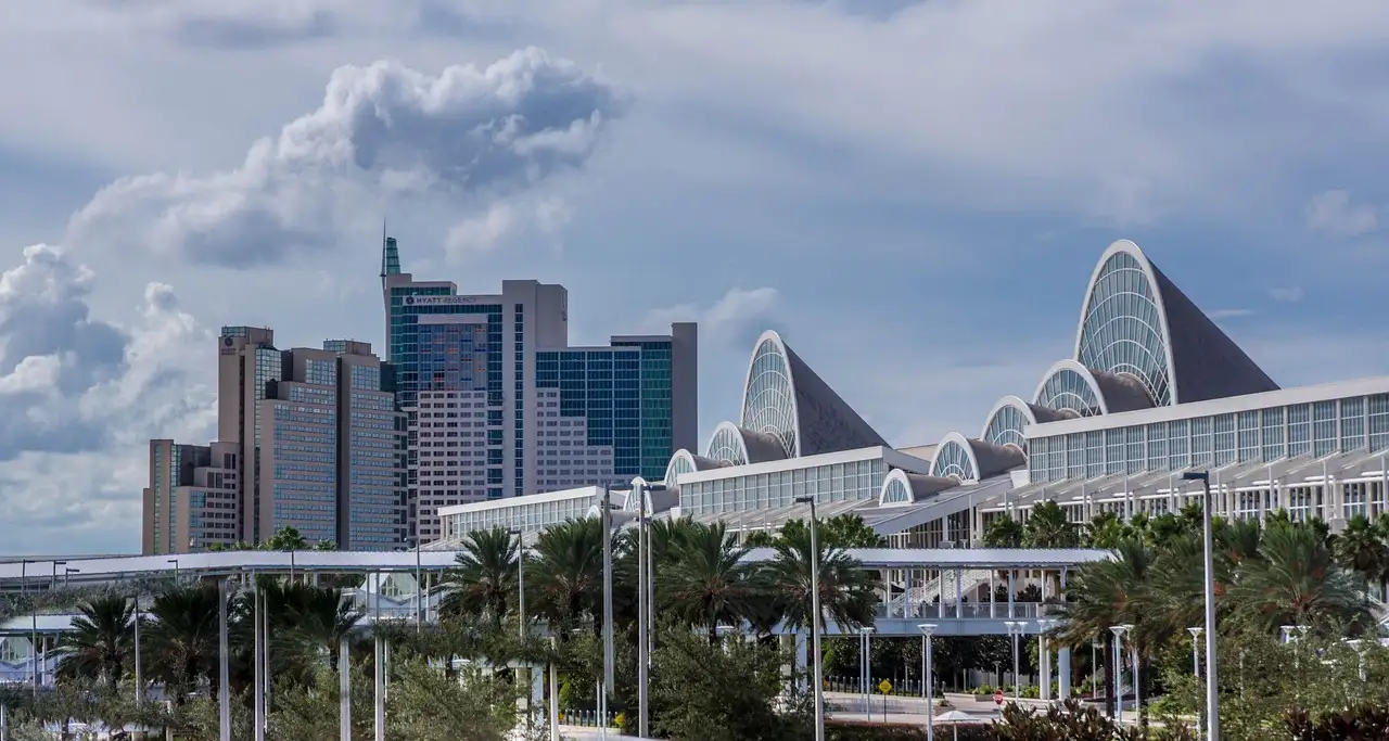 The arched roofs of the Orange County Convention Center with hotel towers behind