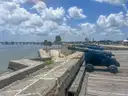 Old cannons on the stone wall of St. Augustine's fort, with the bay behind