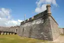 The coquina stone walls and corner watchtower of the Castillo de San Marcos fort in St. Augustine