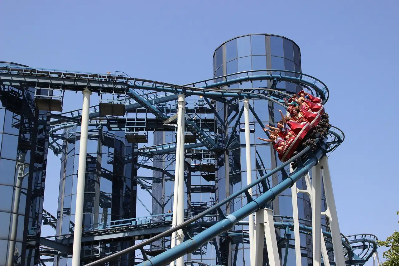 A roller coaster train leaning through a tight steel curve