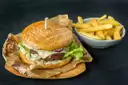 A burger and a bowl of fries served on paper on a table